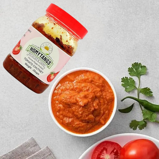 Homytangs tomato and tamarind chutney 400g jar, showing the dark, thick sauce with a glossy texture and label on the jar.